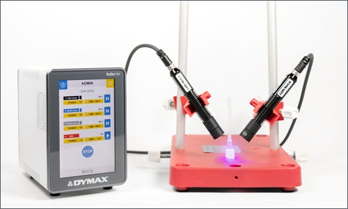 A Dymax Bluewave QX4 LED spot lamp light cures an adhesive on plastic components to quickly bond them together.